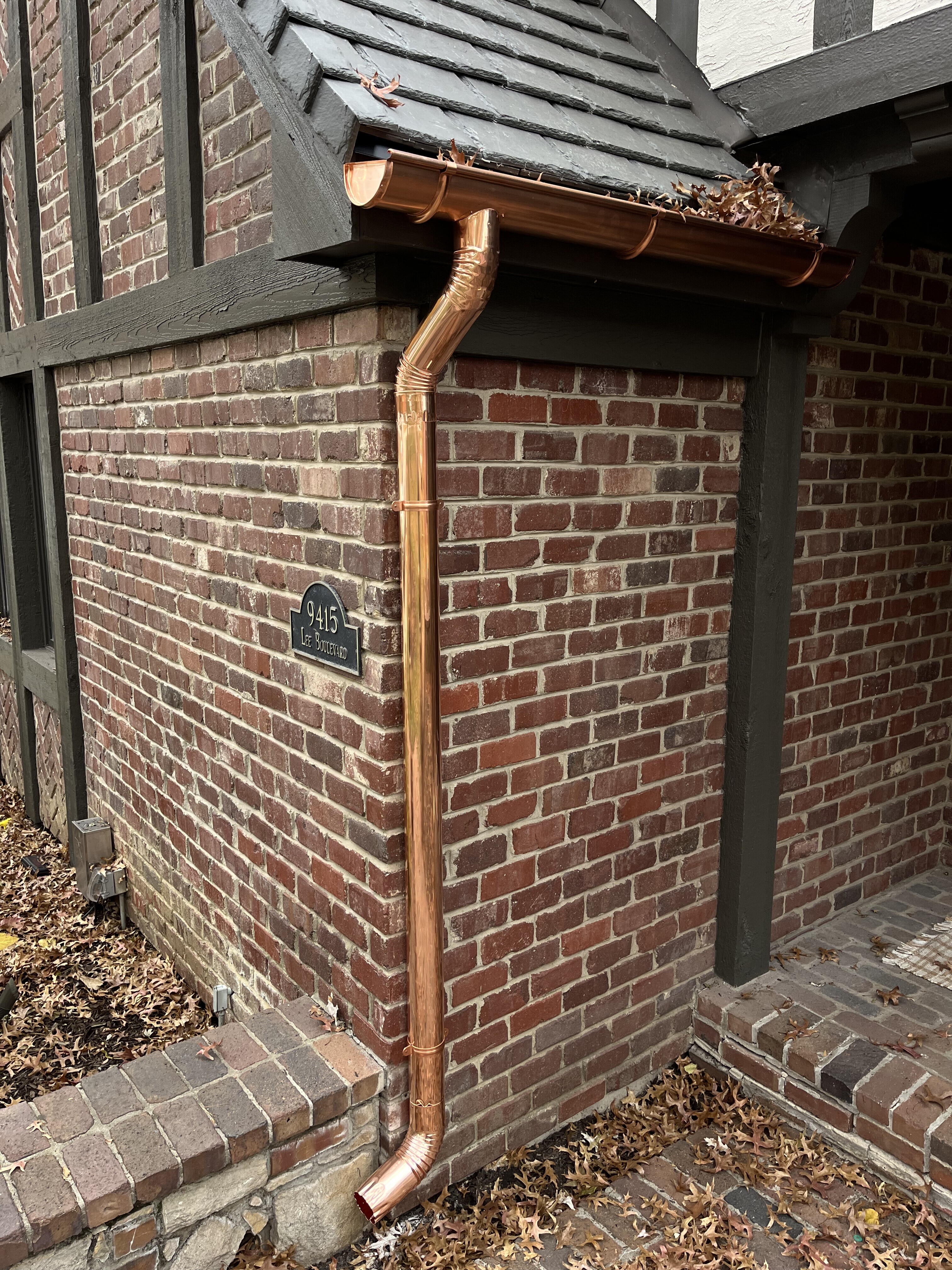 New copper gutter and downspout installation on a house in Leawood, KS