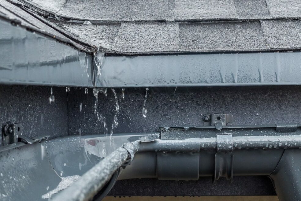 jets of rain drain into the drainage system on the roof of the house