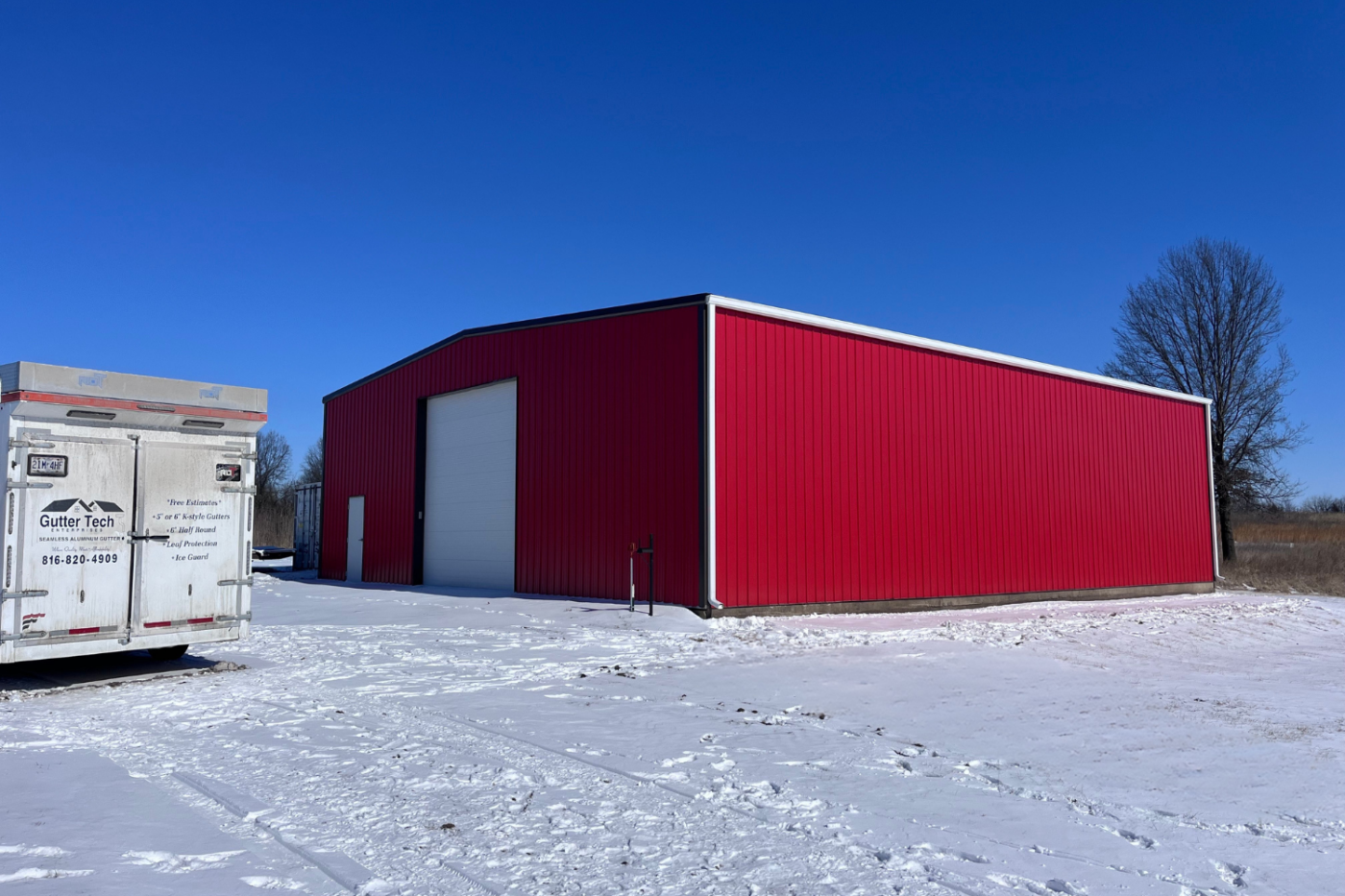 red building with white garage and new gutters